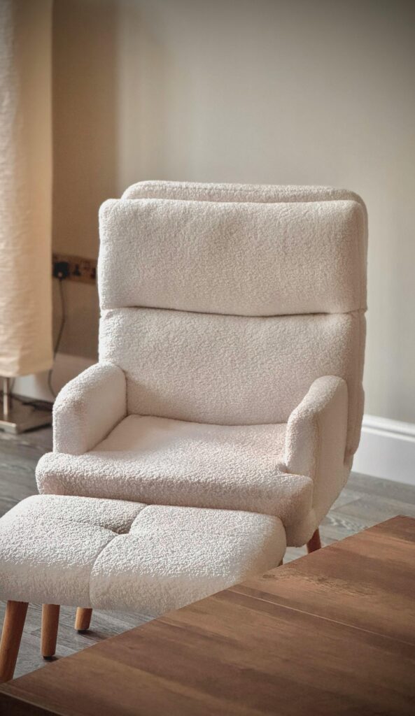 pexels photo 35033907 35033907 Soft beige armchair with footrest in a modern, minimalist living room.